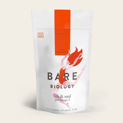 A white pouch of Bare Biologys Life & Soul Omega-3 Fish Oil Daily Capsules is shown, featuring a red label and an illustration of a woman. It highlights 100% Plastic Free and 60 capsules, emphasizing brain and heart health benefits.