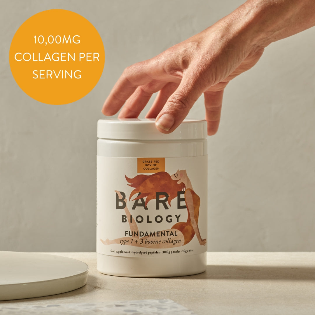 A hand holds a white container of Bare Biology Pure Bovine Collagen Powder with hydrolysed peptides against a neutral background. An orange circle reads 10,000MG COLLAGEN PER SERVING, and the label displays an orange fox illustration.